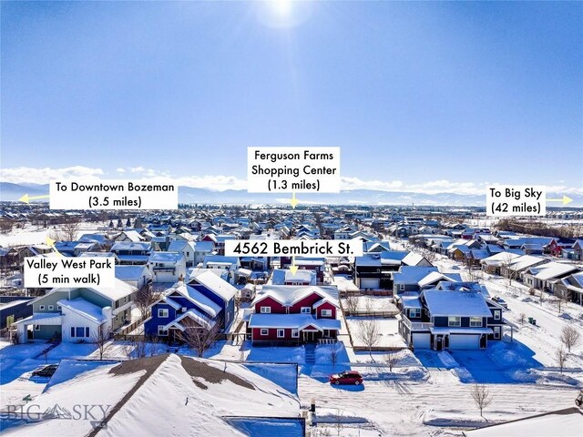 snowy aerial view featuring a mountain view