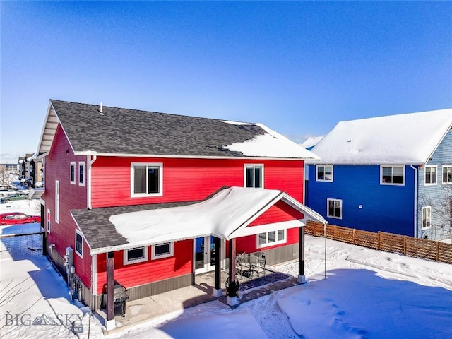 view of snow covered rear of property