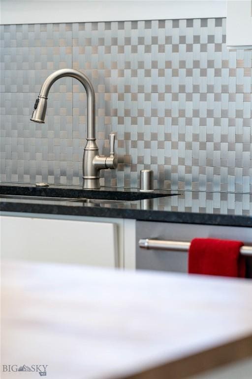 details featuring tasteful backsplash and sink