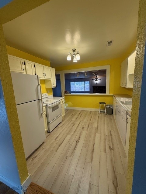 kitchen featuring white cabinets, white appliances, and light hardwood / wood-style floors