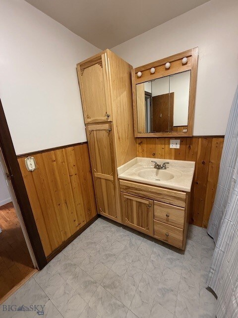 5042 US Highway 89 S, Livingston, MT 59047 - bathroom with wood walls, wainscoting, and vanity