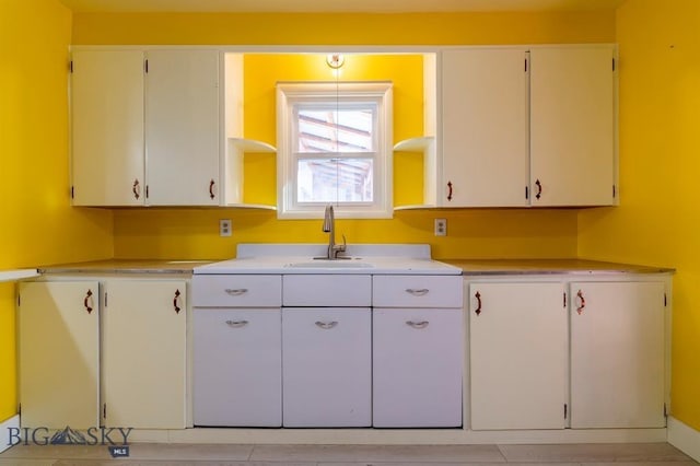 kitchen with white cabinetry and sink