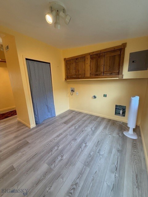 5042 US Highway 89 S, Livingston, MT 59047 - laundry area featuring wood finished floors, electric panel, and baseboards