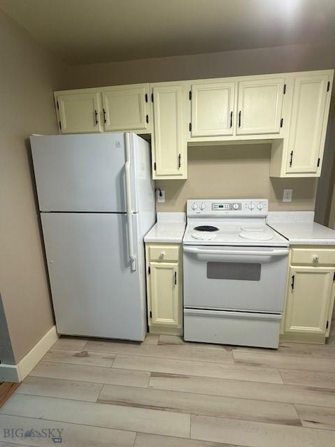5042 US Highway 89 S, Livingston, MT 59047 - kitchen featuring white appliances, light countertops, light wood-style flooring, and white cabinetry