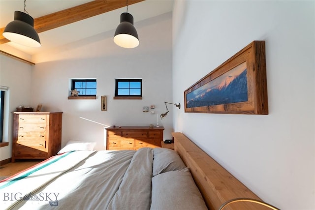 bedroom featuring vaulted ceiling with beams