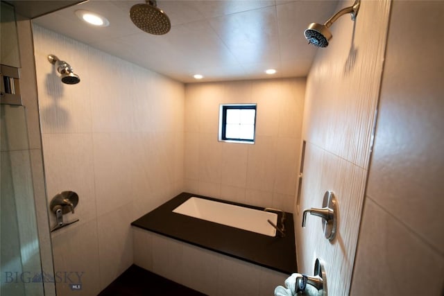 bathroom with tile walls and a shower