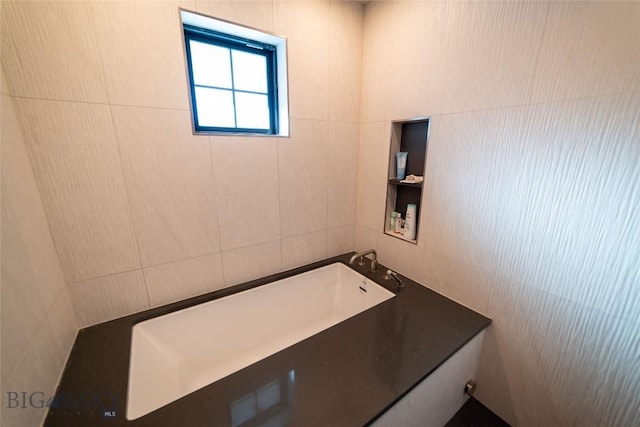 bathroom featuring tile walls