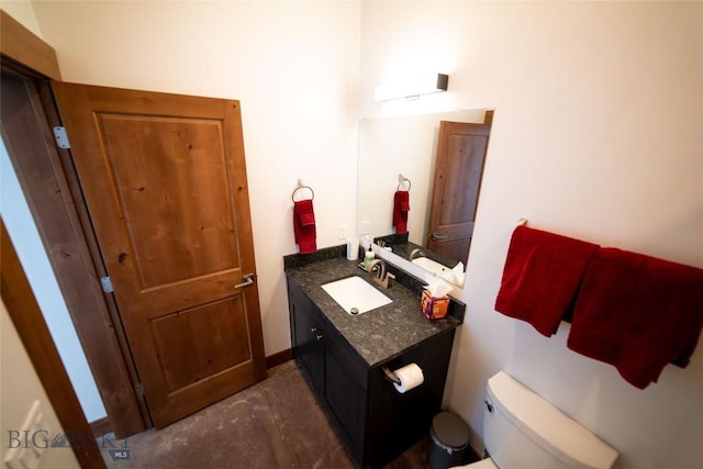 bathroom featuring vanity, toilet, and concrete floors