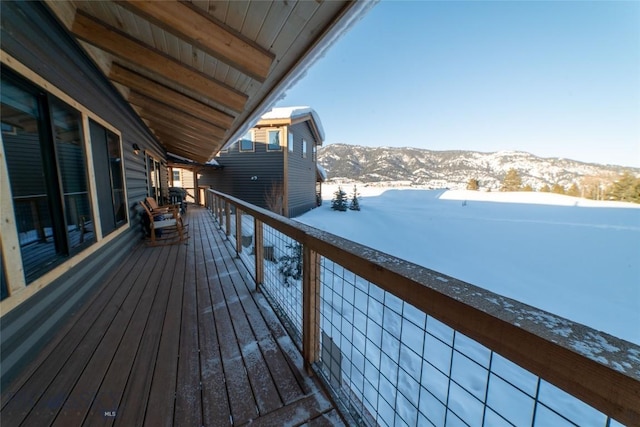 snow covered deck featuring a mountain view