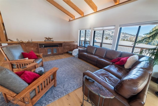 living room featuring hardwood / wood-style floors, a mountain view, high vaulted ceiling, and beamed ceiling