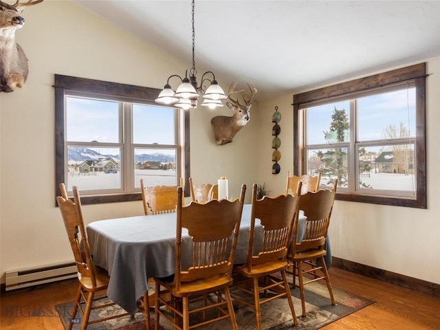 10 Fan Mountain Ct, Ennis, MT 59729 - dining space with vaulted ceiling, wood finished floors, baseboards, a baseboard heating unit, and an inviting chandelier