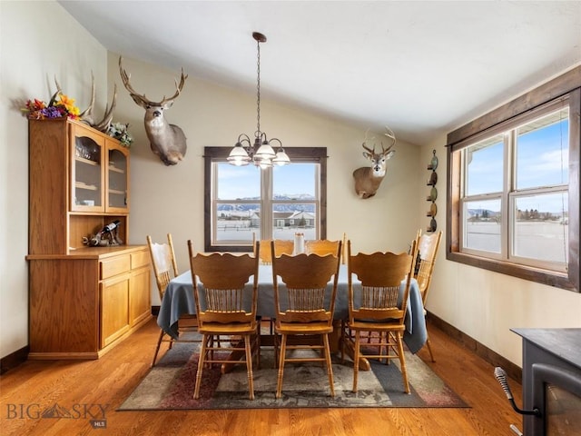 10 Fan Mountain Ct, Ennis, MT 59729 - dining space featuring baseboards, a notable chandelier, lofted ceiling, and light wood-style floors