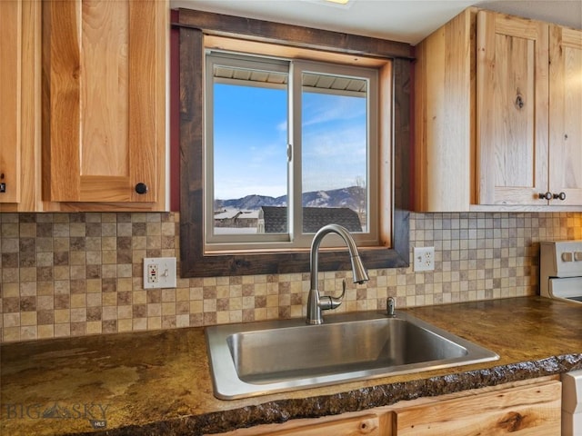 10 Fan Mountain Ct, Ennis, MT 59729 - kitchen with dark countertops, stove, a sink, and tasteful backsplash