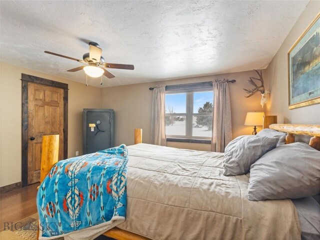 10 Fan Mountain Ct, Ennis, MT 59729 - bedroom with baseboards, a textured ceiling, ceiling fan, and wood finished floors