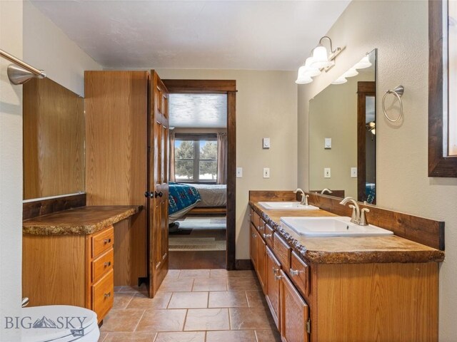 10 Fan Mountain Ct, Ennis, MT 59729 - bathroom featuring double vanity, a sink, and ensuite bath