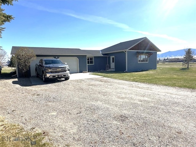 10 Fan Mountain Ct, Ennis, MT 59729 - ranch-style house with a front yard, an attached garage, a mountain view, and driveway