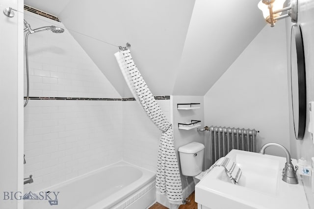 full bathroom featuring tiled shower / bath, lofted ceiling, radiator, and sink