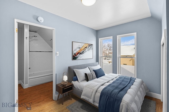 bedroom with lofted ceiling and hardwood / wood-style floors