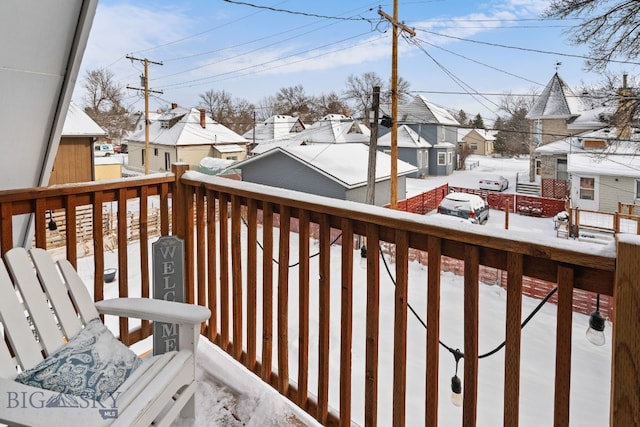 view of snow covered back of property