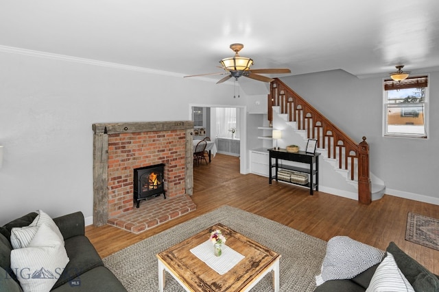 living room with ornamental molding, hardwood / wood-style floors, and ceiling fan