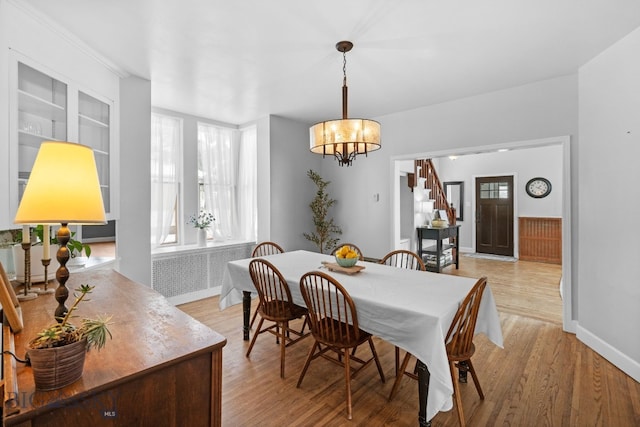 dining room featuring light hardwood / wood-style flooring and a chandelier