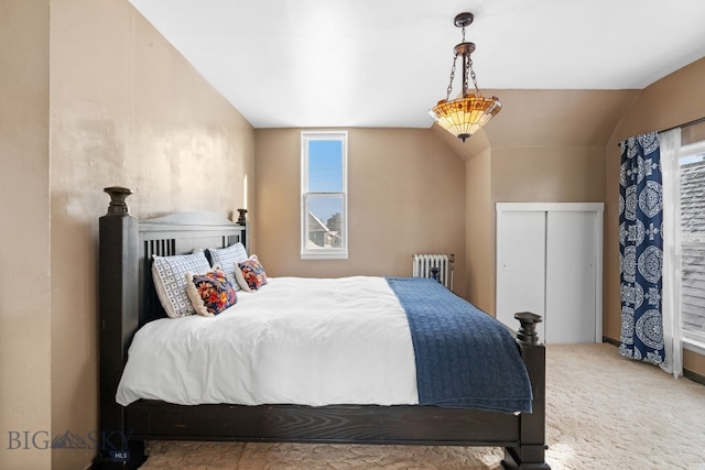 carpeted bedroom featuring radiator and vaulted ceiling