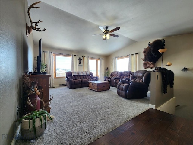 living room featuring hardwood / wood-style flooring, a healthy amount of sunlight, a baseboard radiator, and lofted ceiling