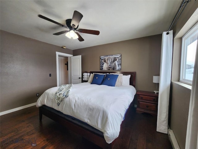 bedroom with ceiling fan and dark wood-type flooring