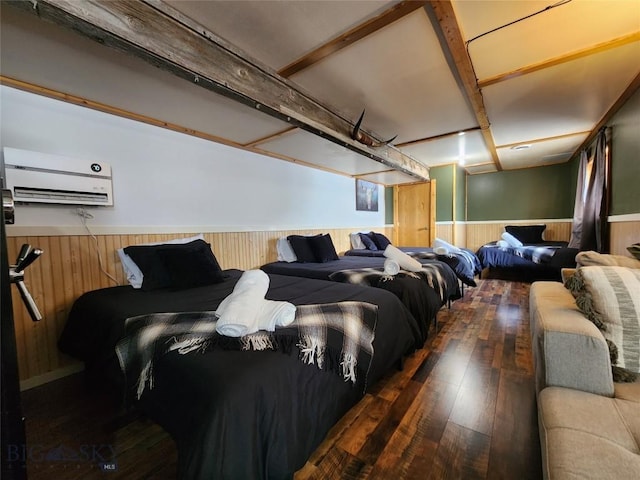 home theater featuring dark hardwood / wood-style floors, a wall mounted air conditioner, and wood walls