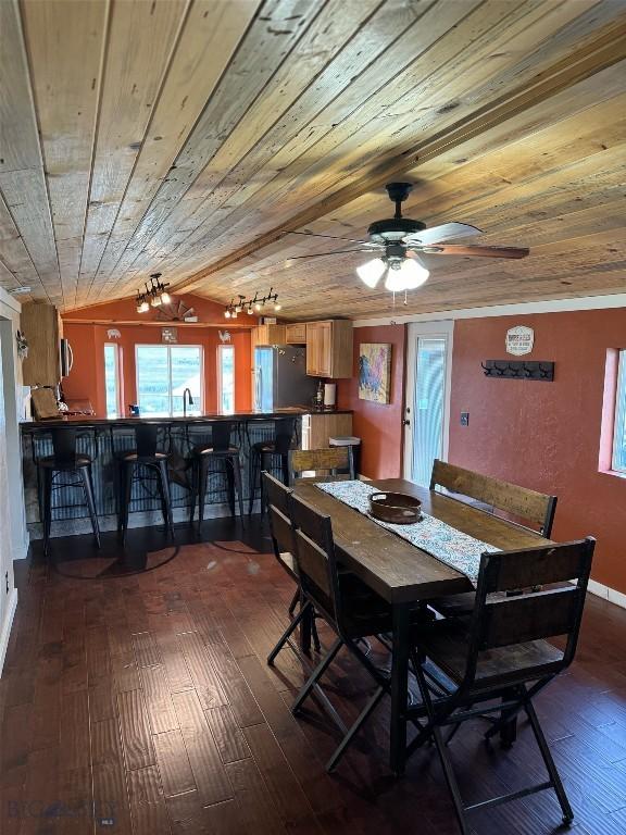 dining room featuring sink, ceiling fan, dark hardwood / wood-style flooring, track lighting, and wood ceiling