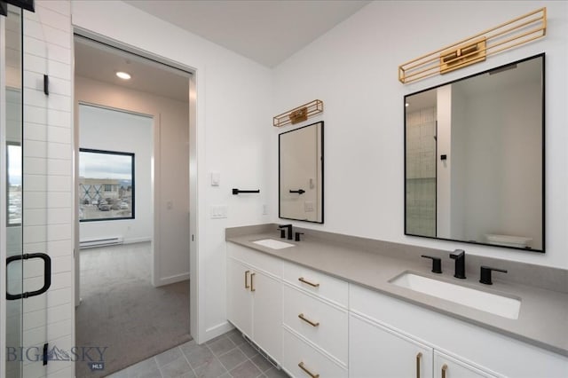 bathroom with tile patterned flooring, a baseboard radiator, vanity, and walk in shower