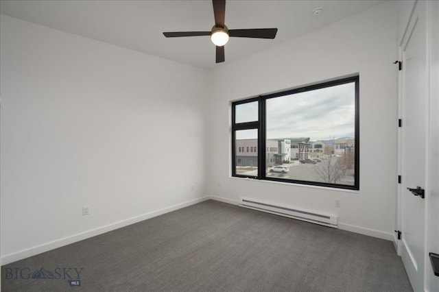 carpeted spare room with a baseboard radiator and ceiling fan