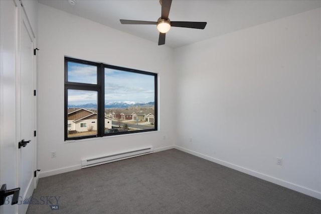 empty room with a baseboard radiator, ceiling fan, and dark carpet