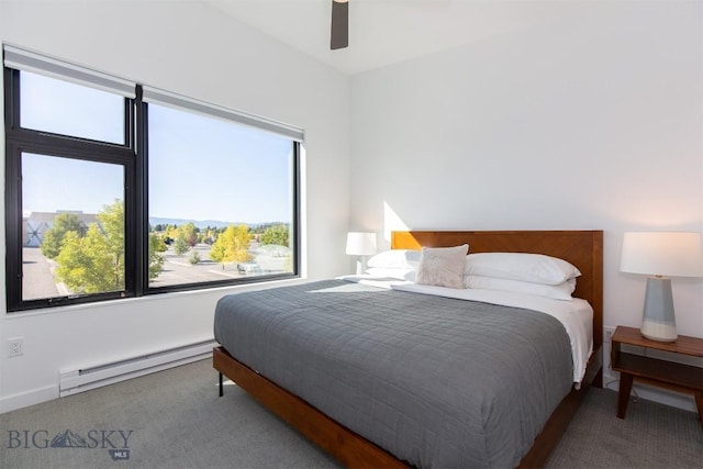 carpeted bedroom with a baseboard radiator and ceiling fan