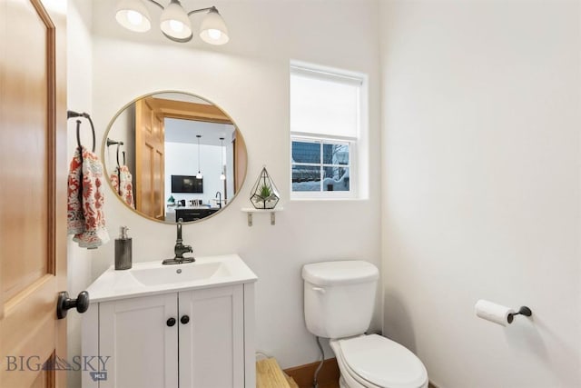 bathroom featuring vanity and toilet