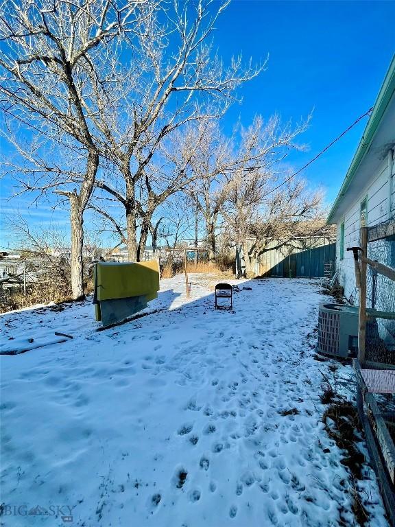 yard covered in snow with central air condition unit