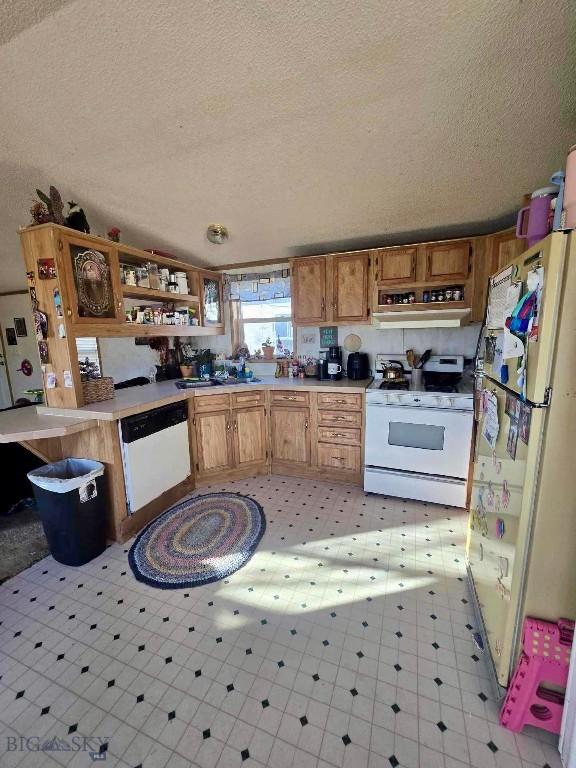 kitchen featuring open shelves, white appliances, light countertops, ventilation hood, and light floors