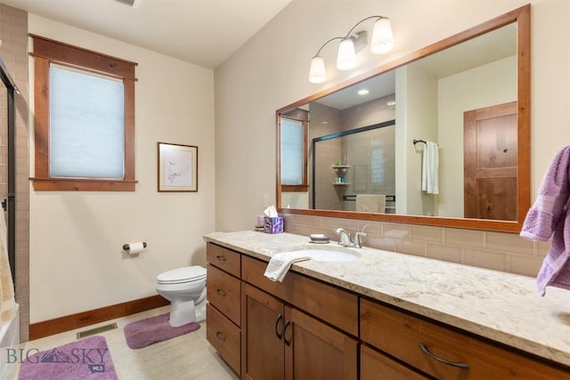 bathroom with walk in shower, vanity, and toilet