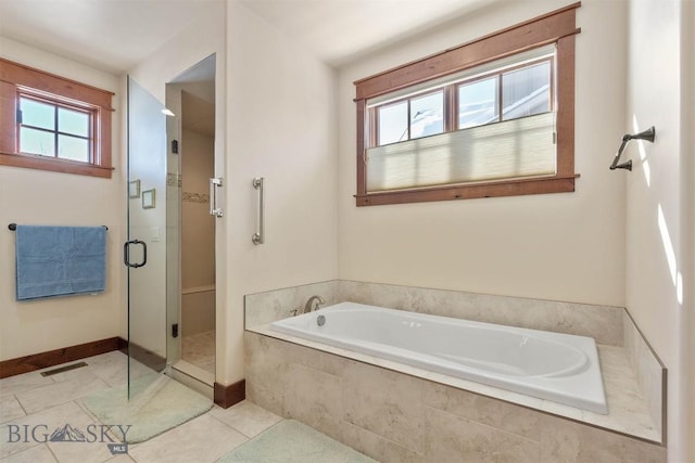 bathroom featuring tile patterned flooring, independent shower and bath, and a healthy amount of sunlight