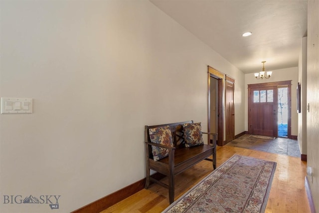 entrance foyer with an inviting chandelier and light hardwood / wood-style floors