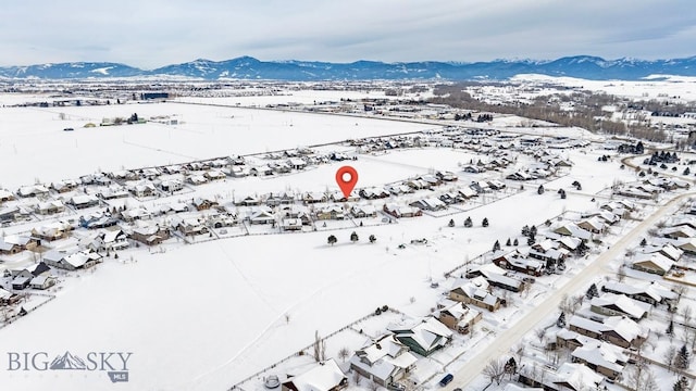 snowy aerial view featuring a mountain view