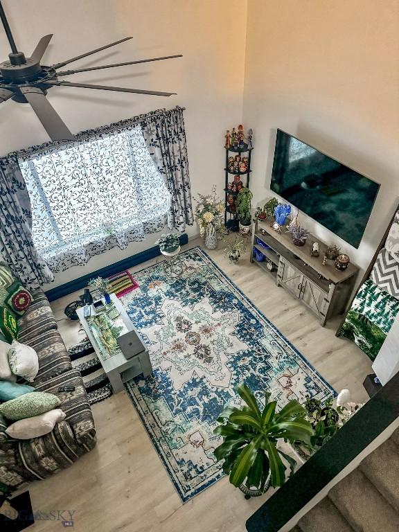 living room featuring ceiling fan and wood-type flooring