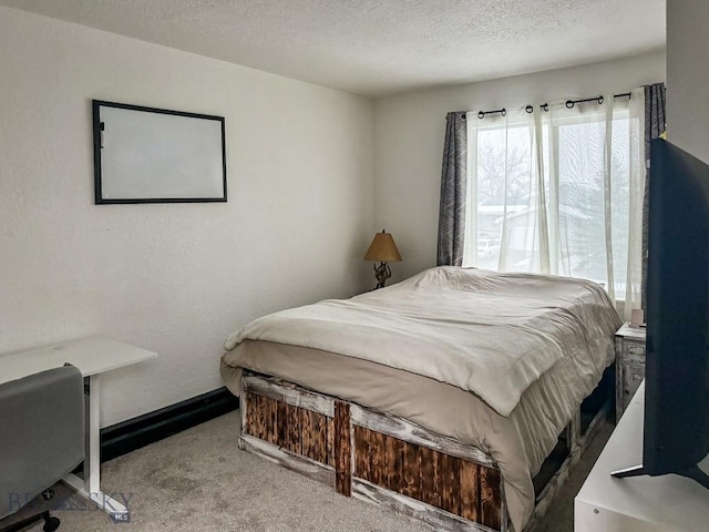 carpeted bedroom featuring a textured ceiling