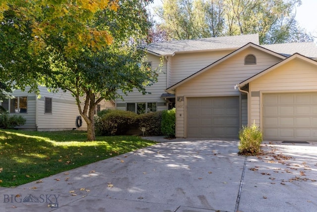 view of front of property with a garage and a front yard