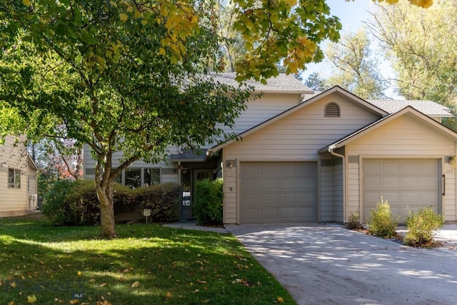 view of front of home with a front lawn and a garage