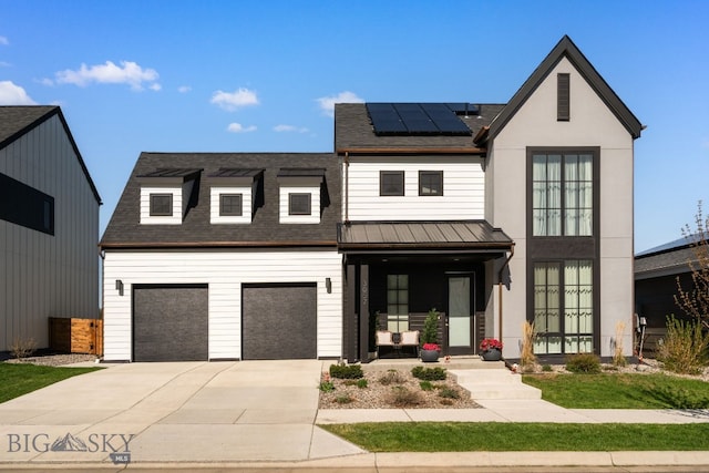 3057 S 31st Ave, Bozeman, MT 59718 - modern farmhouse featuring solar panels, concrete driveway, roof with shingles, and a standing seam roof