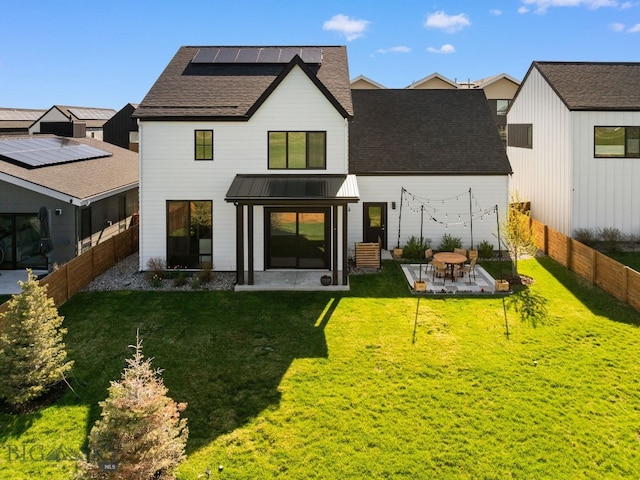 3057 S 31st Ave, Bozeman, MT 59718 - back of property with a patio, a standing seam roof, a fenced backyard, a shingled roof, and a metal roof