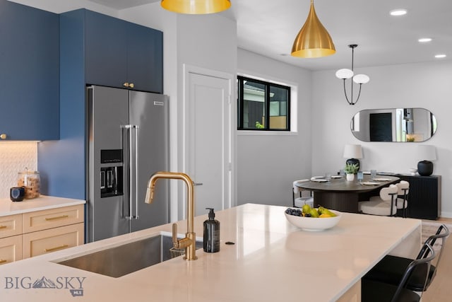 3057 S 31st Ave, Bozeman, MT 59718 - kitchen featuring high end refrigerator, light countertops, a breakfast bar area, decorative light fixtures, and recessed lighting
