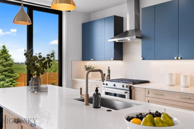 3057 S 31st Ave, Bozeman, MT 59718 - kitchen with wall chimney exhaust hood, blue cabinetry, and decorative backsplash