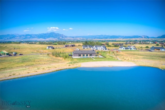 drone / aerial view featuring a water and mountain view